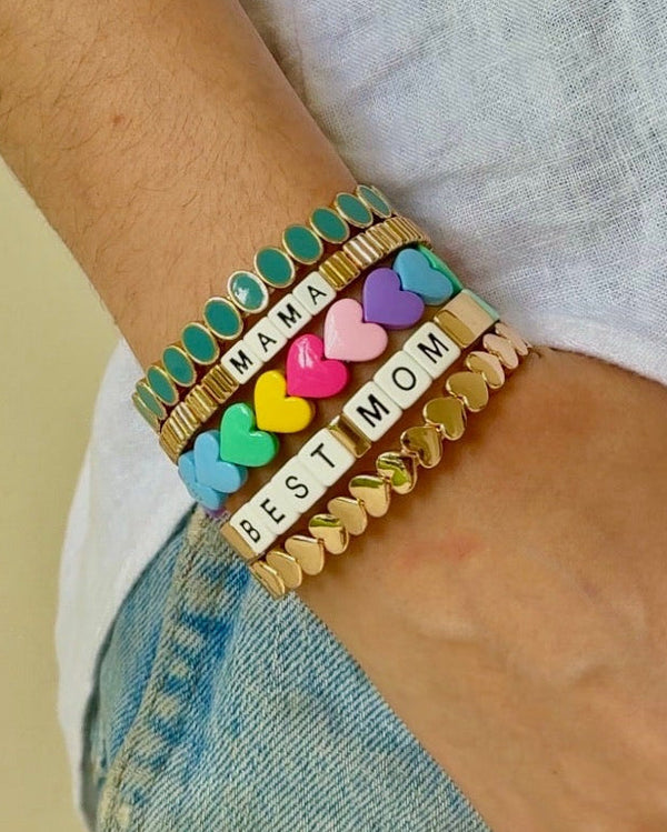 Colorful bracelet with heart-shaped charms and 'MAMA' and  'BEST MOM' text on a wrist.