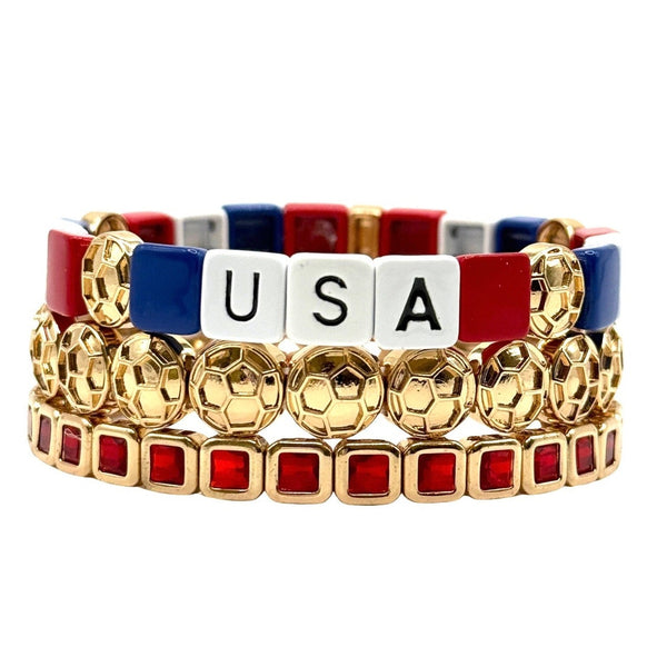 Stack of colorful bracelets with 'USA' on a white background to support Team USA soccer in the world cup.